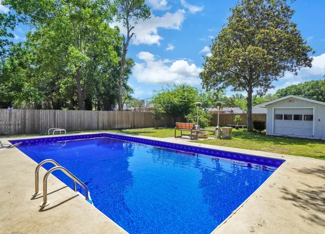 a view of a swimming pool with a lounge chairs