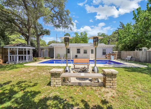 a swimming pool with outdoor seating