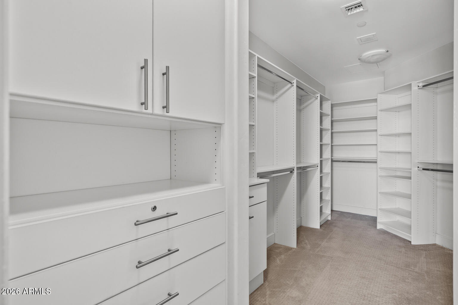 2211 East Camelback Road, Unit 604 Phoenix, AZ 85016 - Photo 12 of 17 a view of walk in closet with empty racks