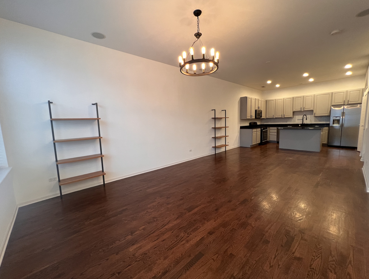 Undisclosed Address Chicago, IL 60610 - Photo 3 of 12 a view of a room with wooden floor and chandelier