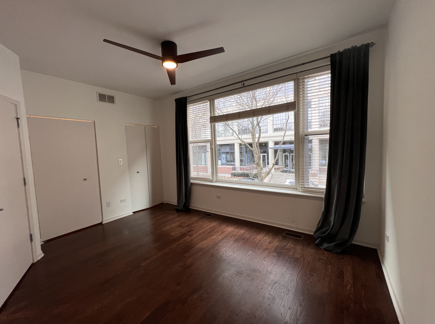Undisclosed Address Chicago, IL 60610 - Photo 6 of 12 a view of an empty room with wooden floor and a window