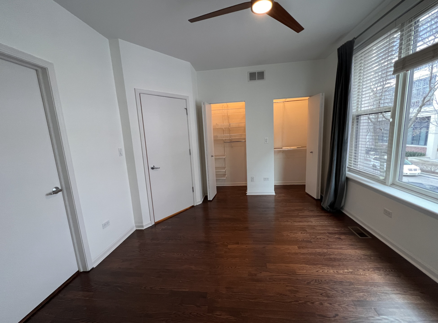 Undisclosed Address Chicago, IL 60610 - Photo 7 of 12 a view of an empty room with window and wooden floor