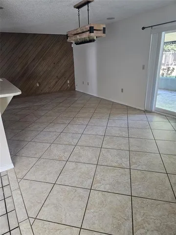 a view of a livingroom with an empty space and a window