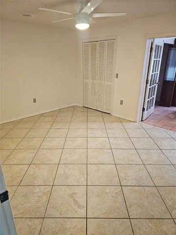 a view of a livingroom with an empty space and a window