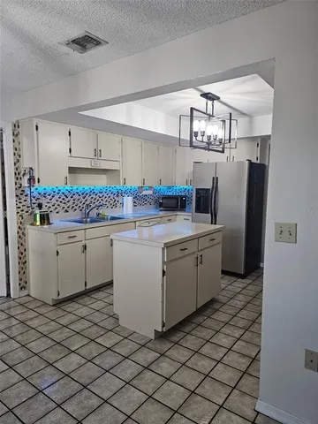 a kitchen with a sink appliances and cabinets