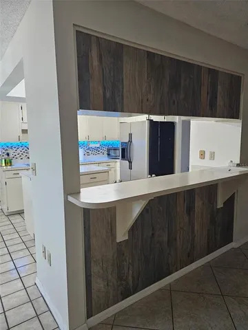 a kitchen with stainless steel appliances a cabinets and a counter top space