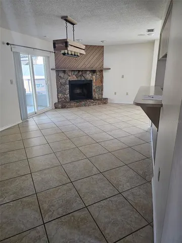 a view of empty room with fireplace