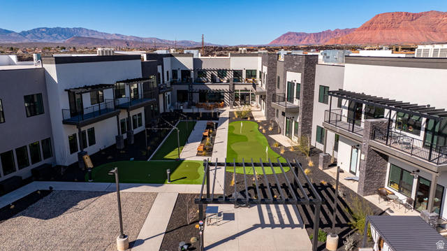 2761 West Lava Hls Road Santa Clara, UT 84765 - Photo 45 of 53 View of community with an area to practice putting, a mountain view, a pergola, and a balcony