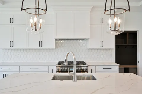 a kitchen with appliances a sink and cabinets