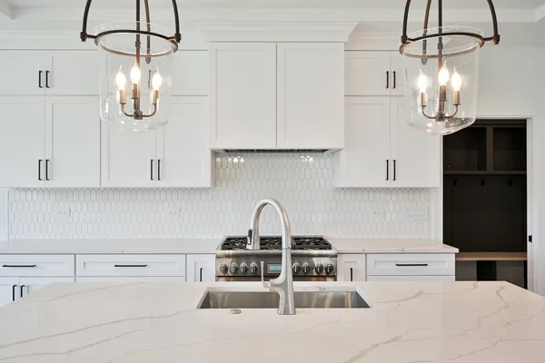 a kitchen with appliances a sink and cabinets