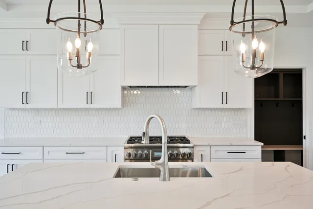 a kitchen with appliances a sink and cabinets