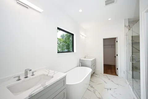 a bathroom with a sink toilet and shower