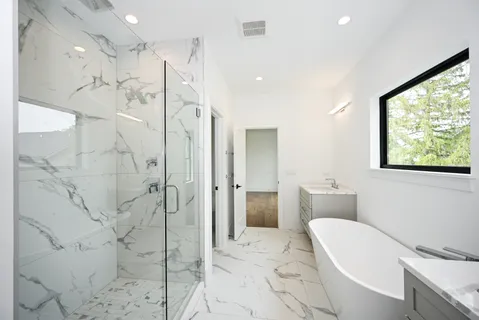 a spacious bathroom with a bathtub and shower