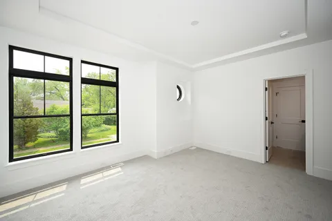 an empty room with windows and closet
