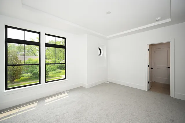 an empty room with windows and closet