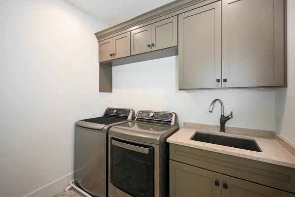 a view of a kitchen with sink and washing machine