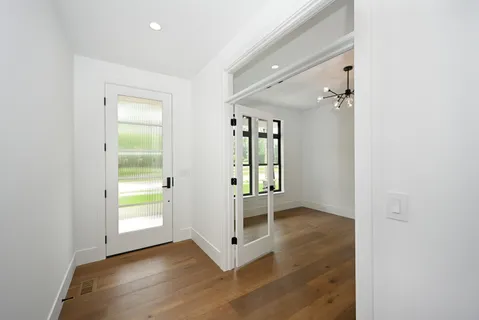 wooden floor in an empty room with a window