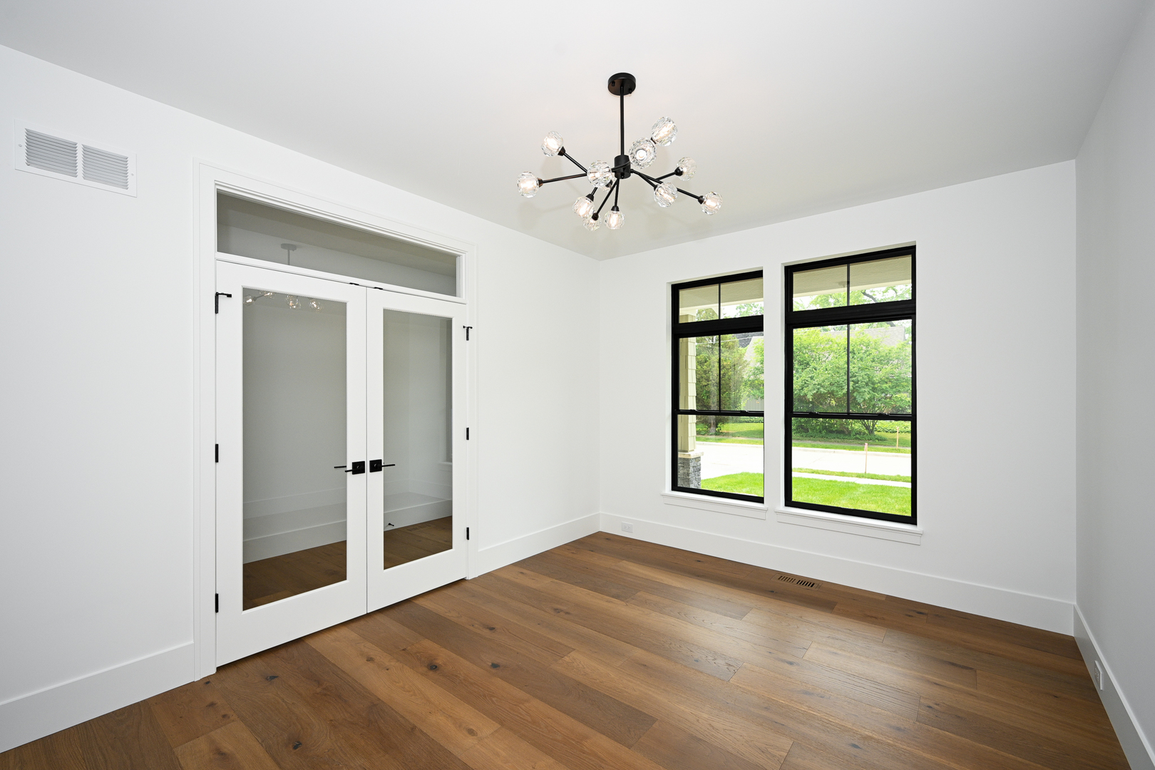 64 Miller Road Lake Zurich, IL 60047 - Photo 4 of 28 a view of an empty room with a window and wooden floor