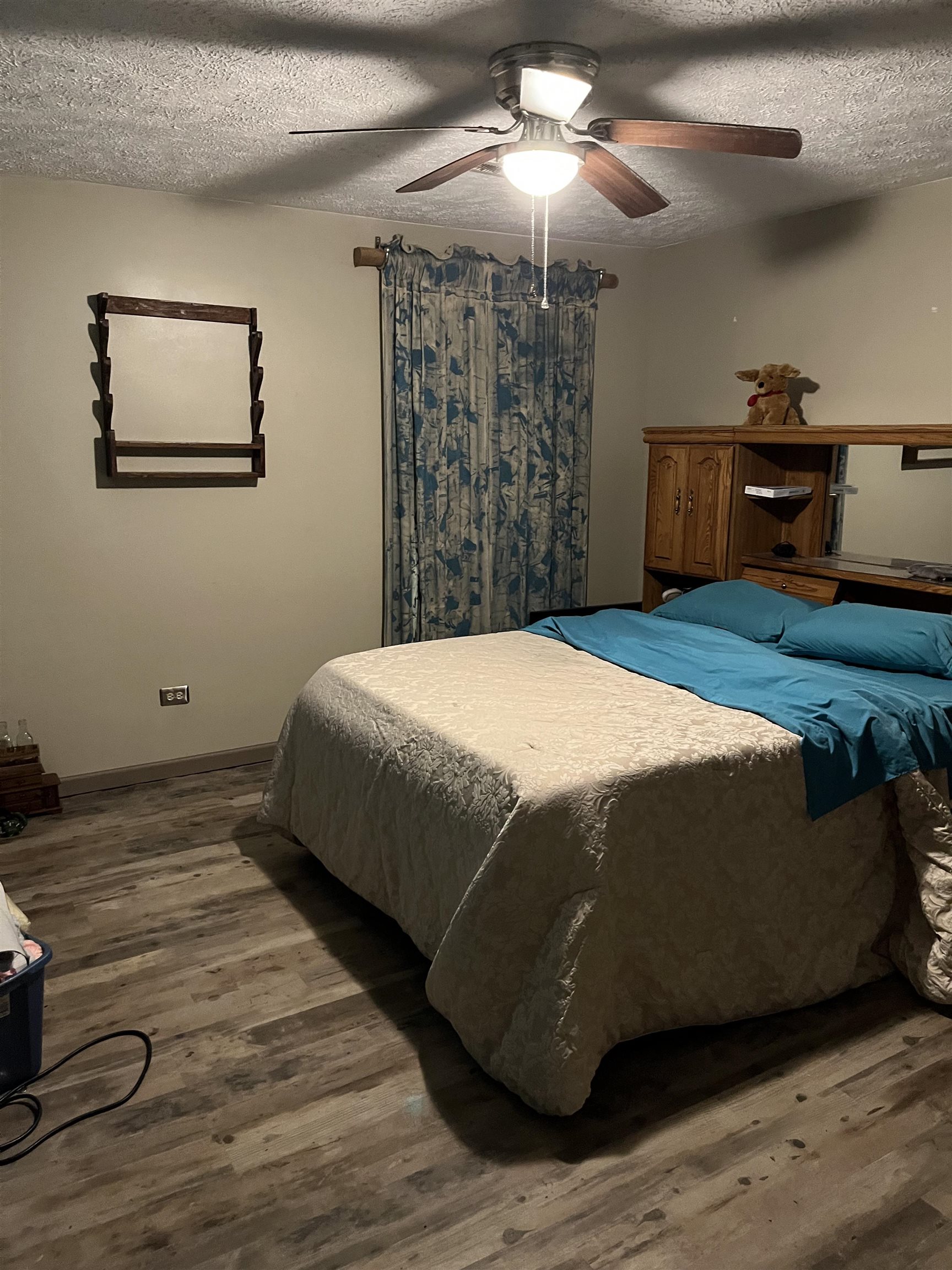 1125 Tyson Road Toone, TN 38381 - Photo 8 of 12 Bedroom featuring wood-finish flooring, a ceiling fan with integrated lighting, and a window with curtain rod