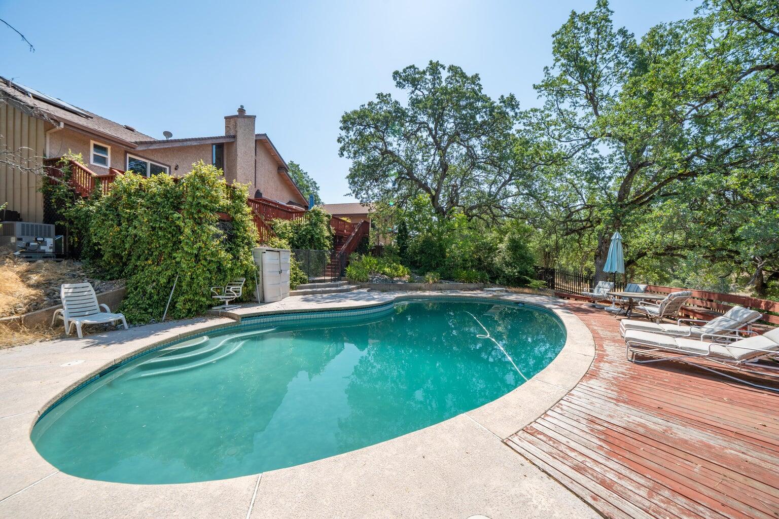 8846 Goldstone Lane Redding, CA 96001 - Photo 54 of 64 a view of a swimming pool with a patio