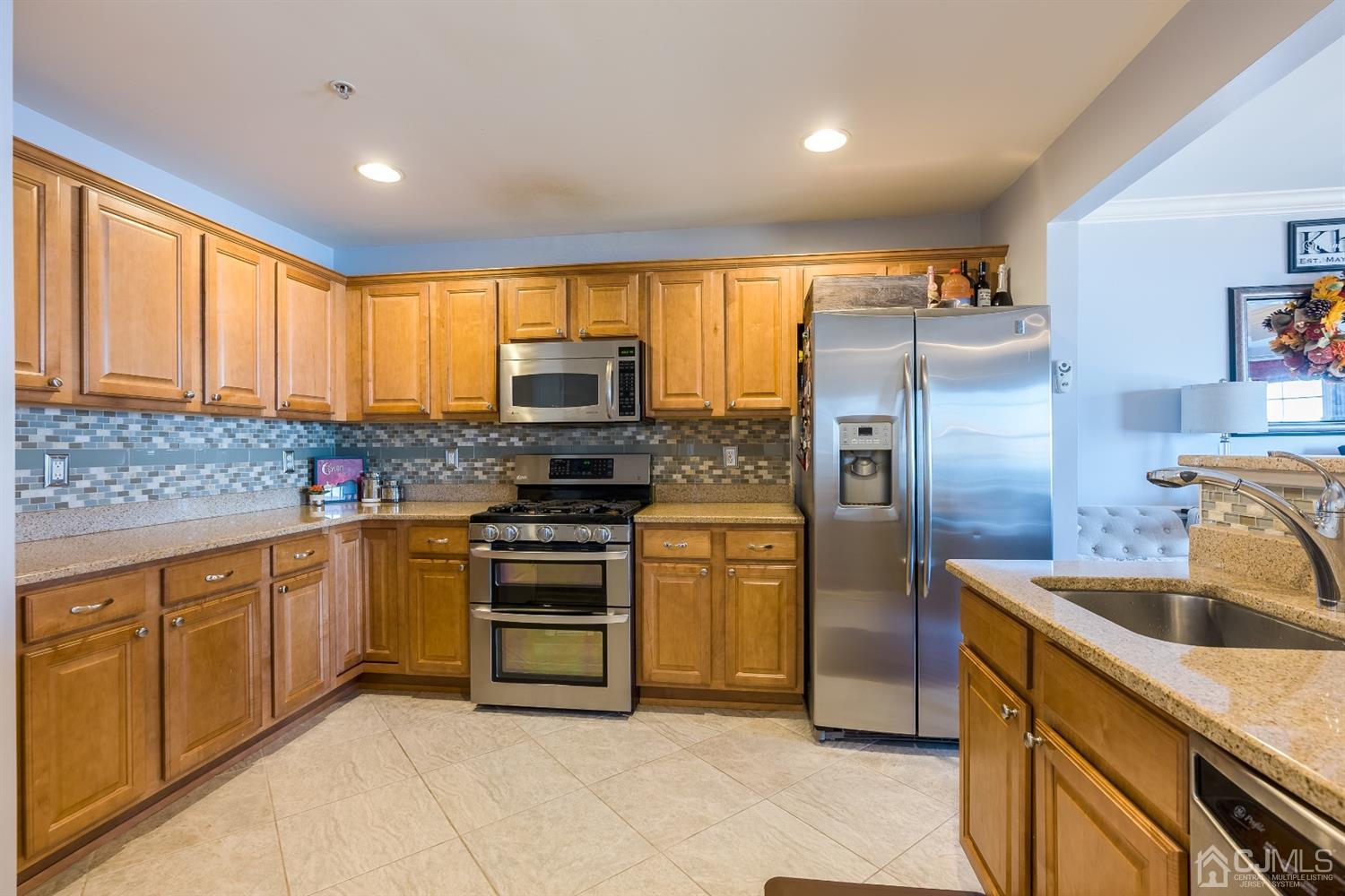 48 Raritan Reach Road South Amboy, NJ 08879 - Photo 10 of 23 a kitchen with stainless steel appliances granite countertop a sink a stove a refrigerator cabinets and a sink