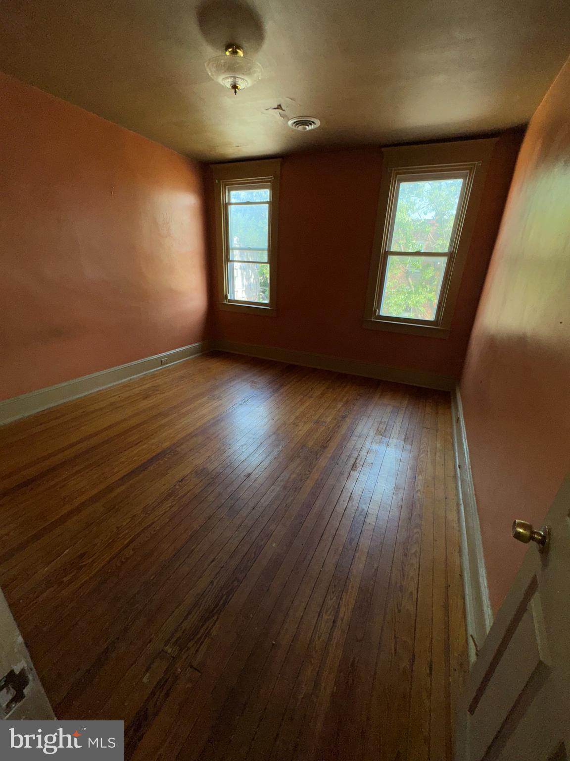 3003 Lyttleton Road Baltimore, MD 21216 - Photo 20 of 27 an empty room with wooden floor and windows