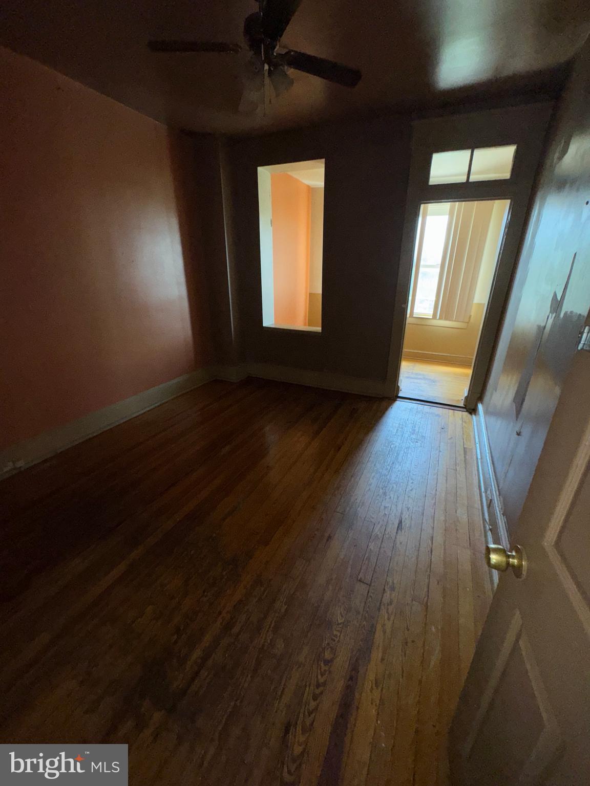 3003 Lyttleton Road Baltimore, MD 21216 - Photo 23 of 27 an empty room with wooden floor and windows