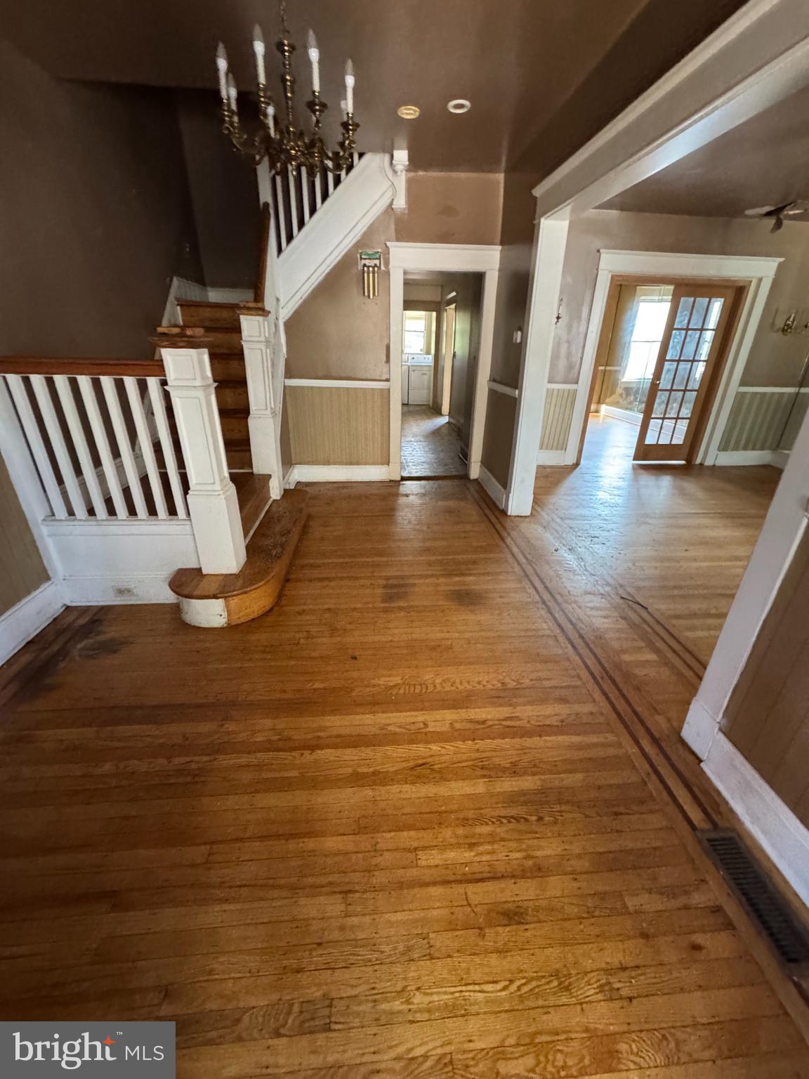 3003 Lyttleton Road Baltimore, MD 21216 - Photo 3 of 27 a view of an empty room with wooden floor and stairs