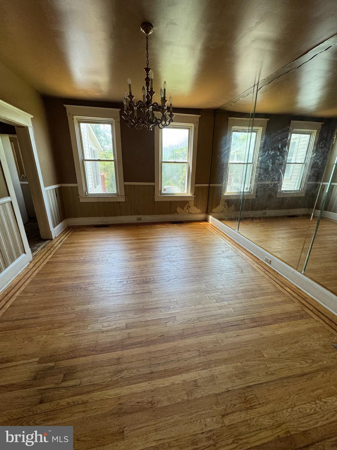 3003 Lyttleton Road Baltimore, MD 21216 - Photo 6 of 27 an empty room with wooden floor and windows
