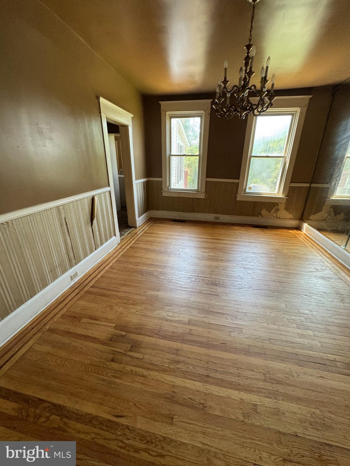 3003 Lyttleton Road Baltimore, MD 21216 - Photo 7 of 27 a view of an empty room with wooden floor and a window
