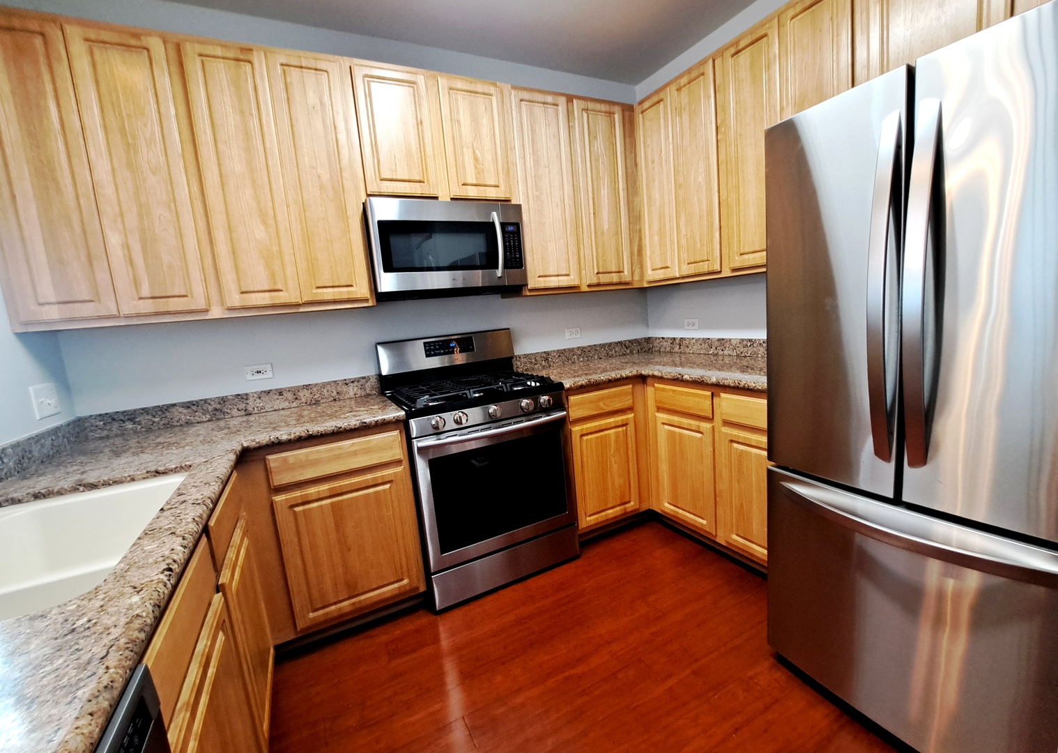 1307 West Lake Street, Unit 304 Addison, IL 60101 - Photo 11 of 33 a kitchen with granite countertop white cabinets and stainless steel appliances