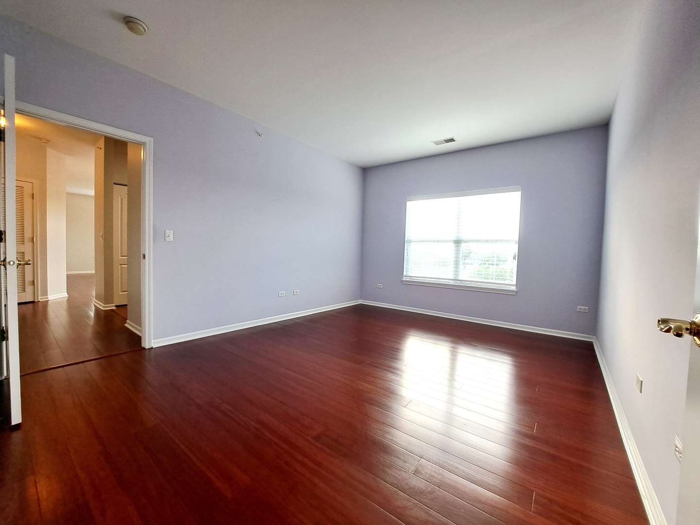 1307 West Lake Street, Unit 304 Addison, IL 60101 - Photo 13 of 33 an empty room with wooden floor and windows