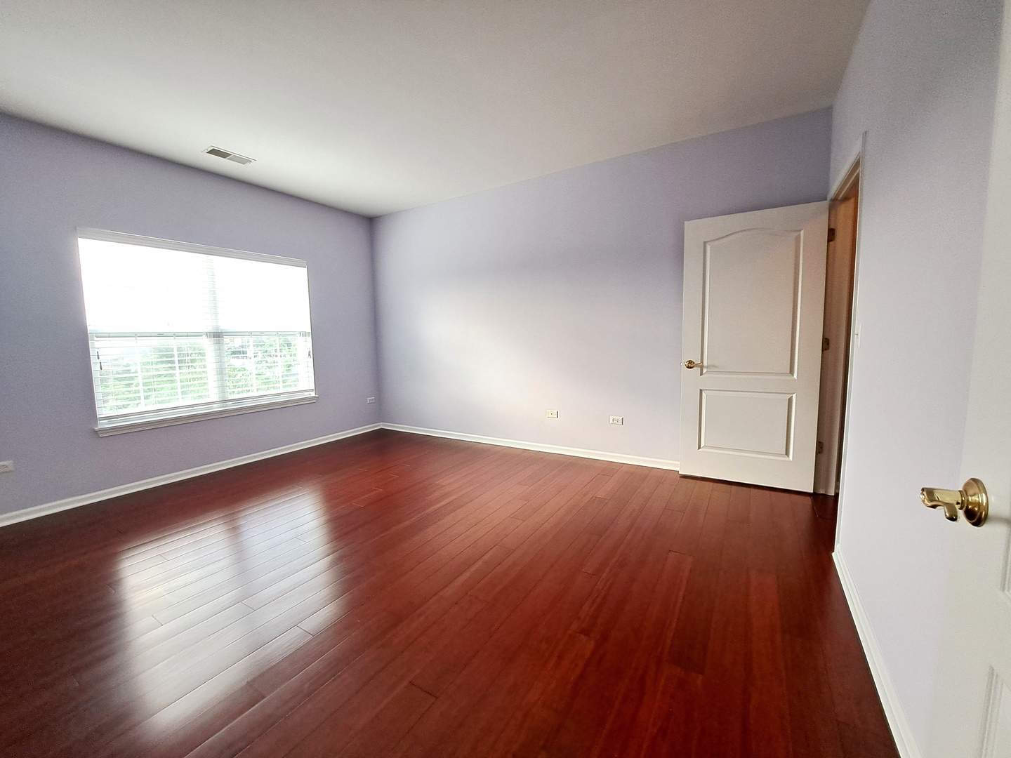 1307 West Lake Street, Unit 304 Addison, IL 60101 - Photo 14 of 33 an empty room with wooden floor and windows