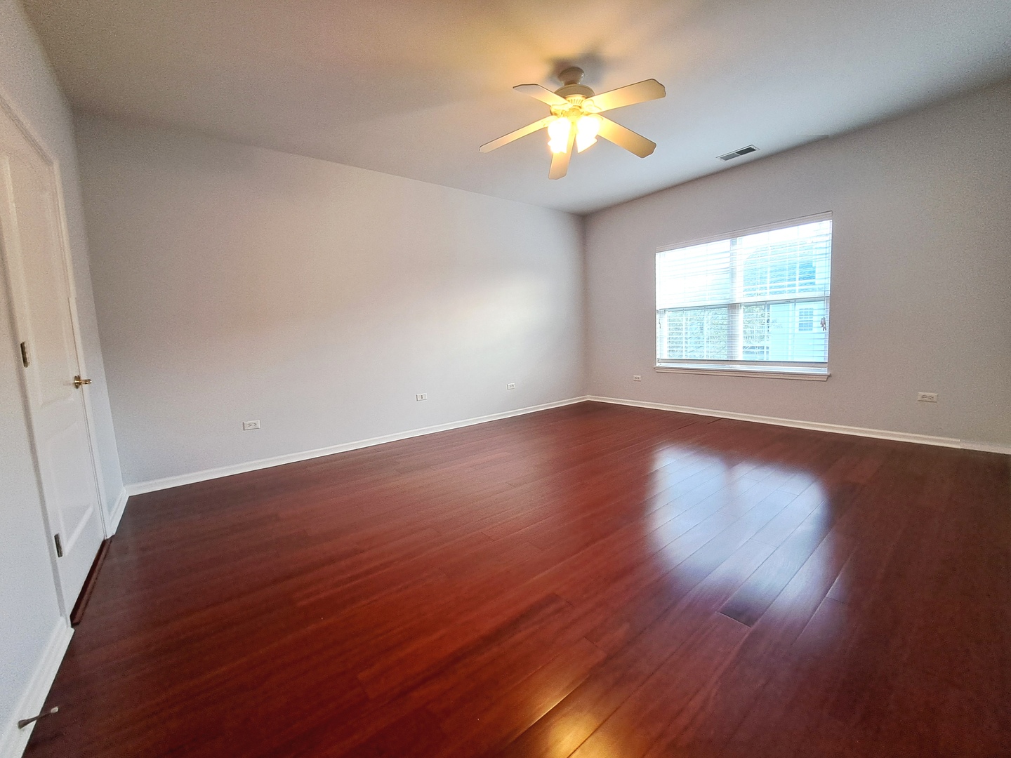 1307 West Lake Street, Unit 304 Addison, IL 60101 - Photo 17 of 33 a view of an empty room with wooden floor and a window