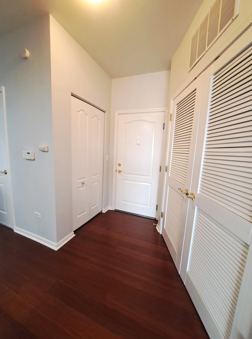 1307 West Lake Street, Unit 304 Addison, IL 60101 - Photo 26 of 33 a view of a hallway with wooden floor