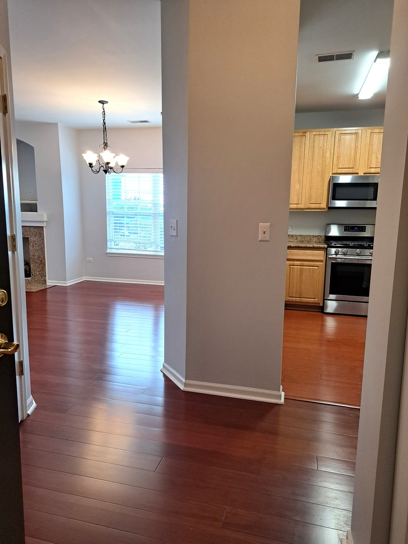 1307 West Lake Street, Unit 304 Addison, IL 60101 - Photo 27 of 33 a view of kitchen with furniture and wooden floor