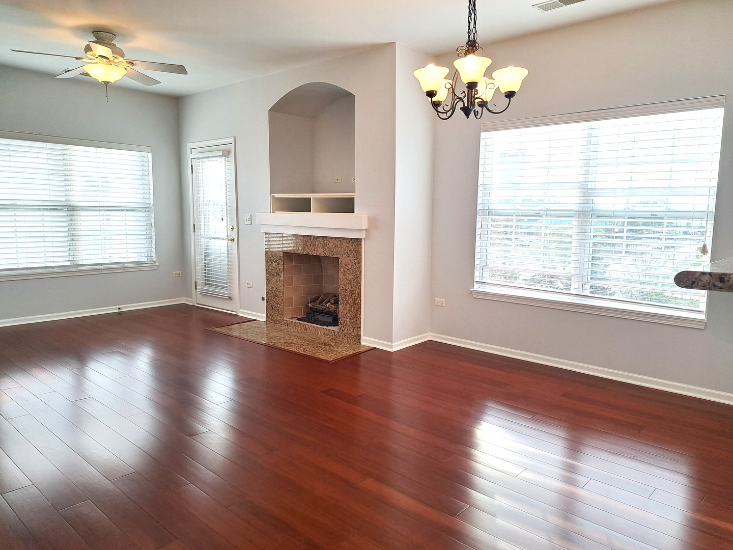 1307 West Lake Street, Unit 304 Addison, IL 60101 - Photo 5 of 33 a view of an empty room with a window and wooden floor