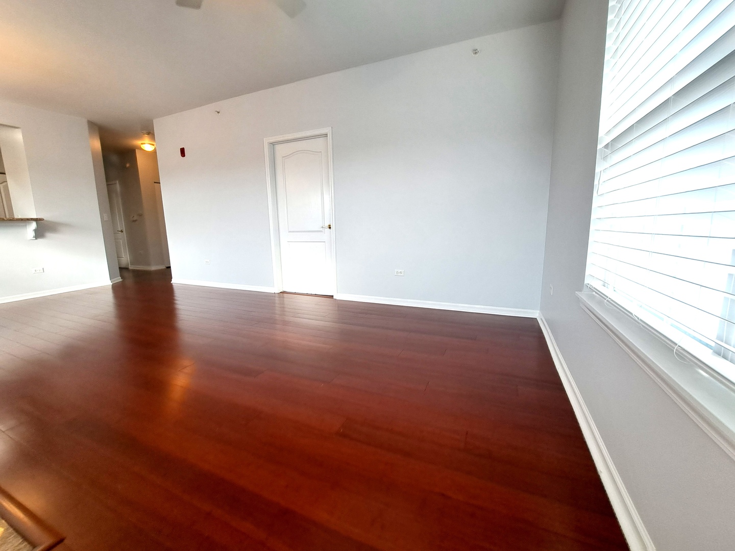 1307 West Lake Street, Unit 304 Addison, IL 60101 - Photo 7 of 33 a view of an empty room with wooden floor and a window