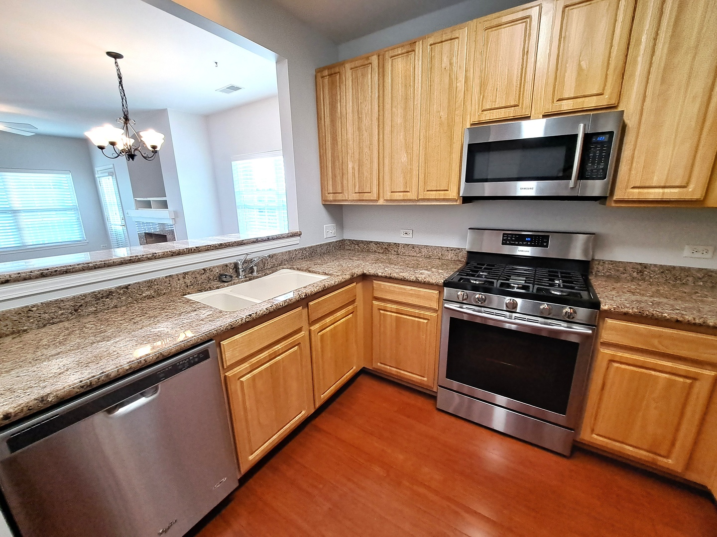 1307 West Lake Street, Unit 304 Addison, IL 60101 - Photo 9 of 33 a kitchen with granite countertop a sink stainless steel appliances and cabinets