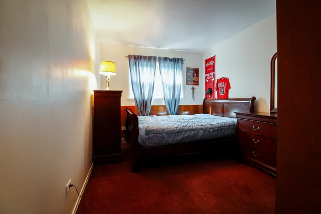 a bed room with a bed and a window