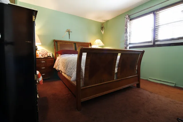 a bedroom with a bed and window