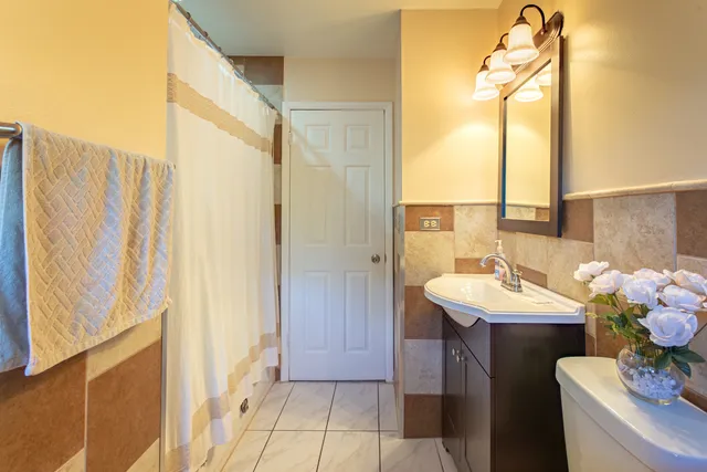 a bathroom with a sink a mirror and a shower