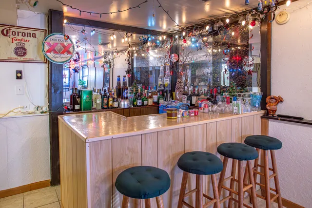 a kitchen area with granite countertop a table and chairs