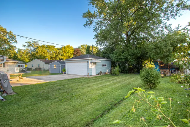 a house view with a sitting space and garden