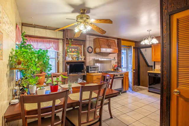a view of a dining room with furniture and a chandelier