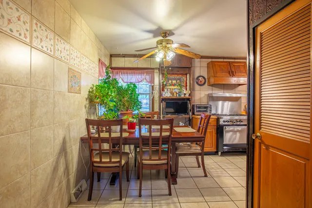 a view of a dining room with furniture and chandelier