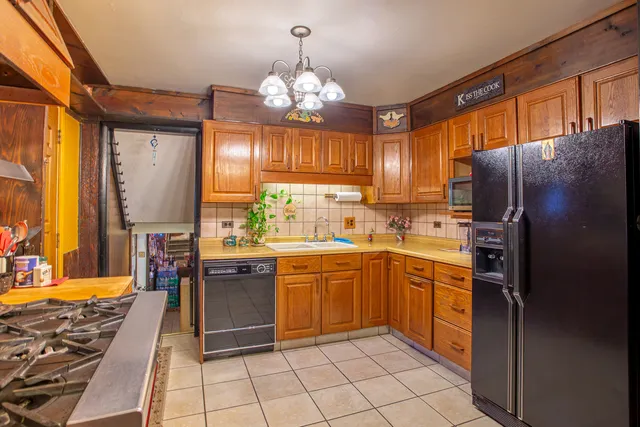 a kitchen with stainless steel appliances granite countertop a refrigerator and a sink