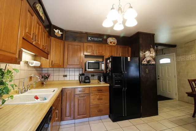 a kitchen with a sink cabinets and stainless steel appliances