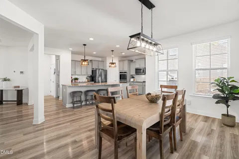 a kitchen with stainless steel appliances granite countertop a sink a stove and a wooden floors