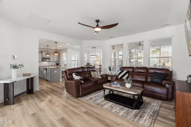 a view of a roof deck with wooden fence and a couple of chairs